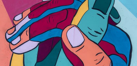 mural colorful hands clasped together