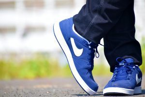 close up of feet wearing blue Nike shoes
