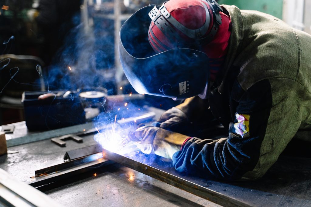 A person welding metal bars