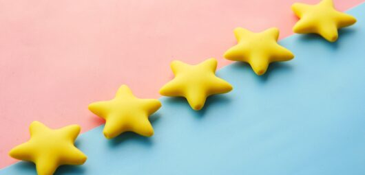 five yellow stars on blue and pink background